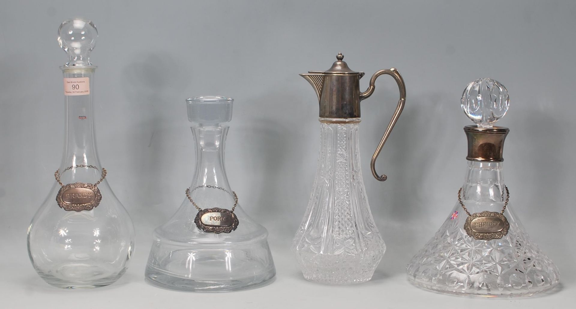 A group of four 20th century glass decanters, to include two plain glass decanters with stoppers and