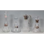 A group of four 20th century glass decanters, to include two plain glass decanters with stoppers and