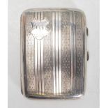 An early 20th Century Art Deco English silver hallmarked cigarette case of rectangular bowed form