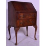 A Queen Ann style 20th Century mahogany bureau raised on cabriol legs with carved shell