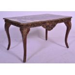 A 20th Century Rococo style coffee table of serpentine form having acanthus leaf gilt wood