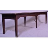 A very large early 20th century country house refectory dining table being raised on 6 legs of