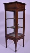 An Edwardian mahogany inlaid pedestal bijouterie display cabinet vitrine. Raised on square legs with