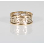 A stamped 375 9ct gold two tone ring having a pierced decoration celtic knot design in white gold