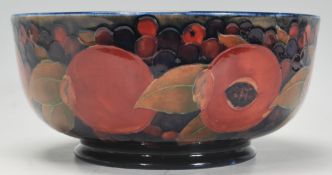 A early 20th Century William Moorcroft centrepiece bowl in Pomegranate pattern on blue ground. On