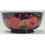 A early 20th Century William Moorcroft centrepiece bowl in Pomegranate pattern on blue ground. On