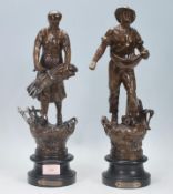 A pair of 20th Century French bronze cast metal figurines, the male figure depicted scattering