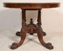 A Victorian 19th century Aesthetic movement walnut tilt top oval breakfast  / loo table. Raised on