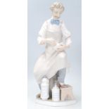 A Lladro porcelain figure of the 'Pharmacist' shown seated with a pestle and mortar. Marks to base