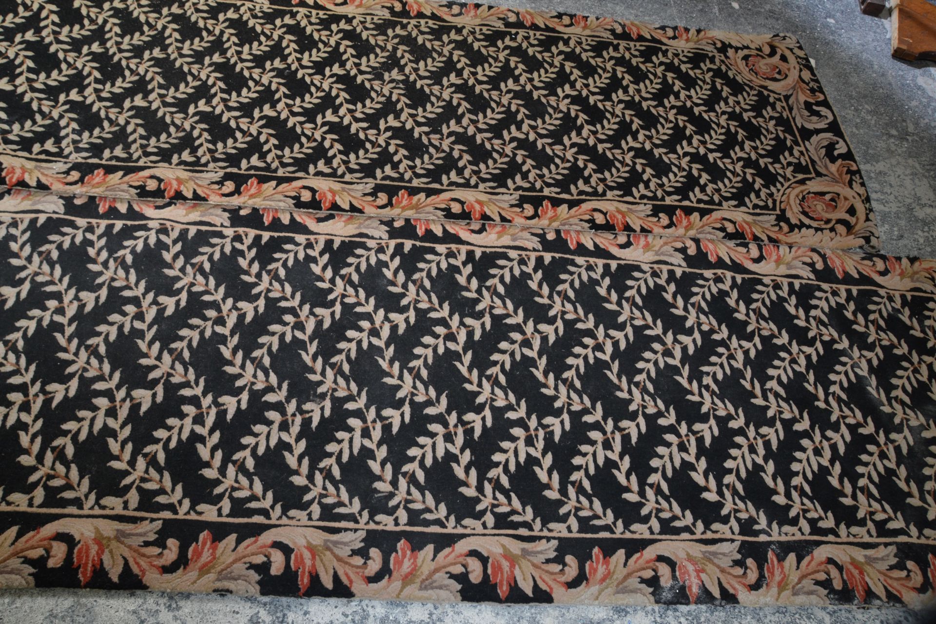 A matching pair of vintage 20th Century floor rug runners having black ground with cream floral - Image 3 of 5