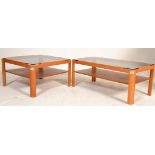 Two vintage retro 1970's Meyers teak wood coffee tables having rounded legs with lower shelves and