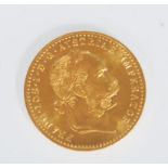 An 18ct gold Austrian 1 Ducat coin (restrike) having a head facing right and coat of arms to the