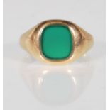 A hallmarked 9ct gold signet ring having a rectangular green stone panel to the head. Hallmarked