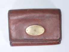 A vintage Mulberry ladies brown leather purse of folding design having a brass oval panel to the