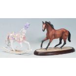 A Brooks & Bentley Thoroughbred "Champion of the wind" horse figure raised on a wooden plinth