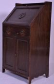 An early 20th Century 1920's dark oak students bureau having a carved Lancashire rose to the full