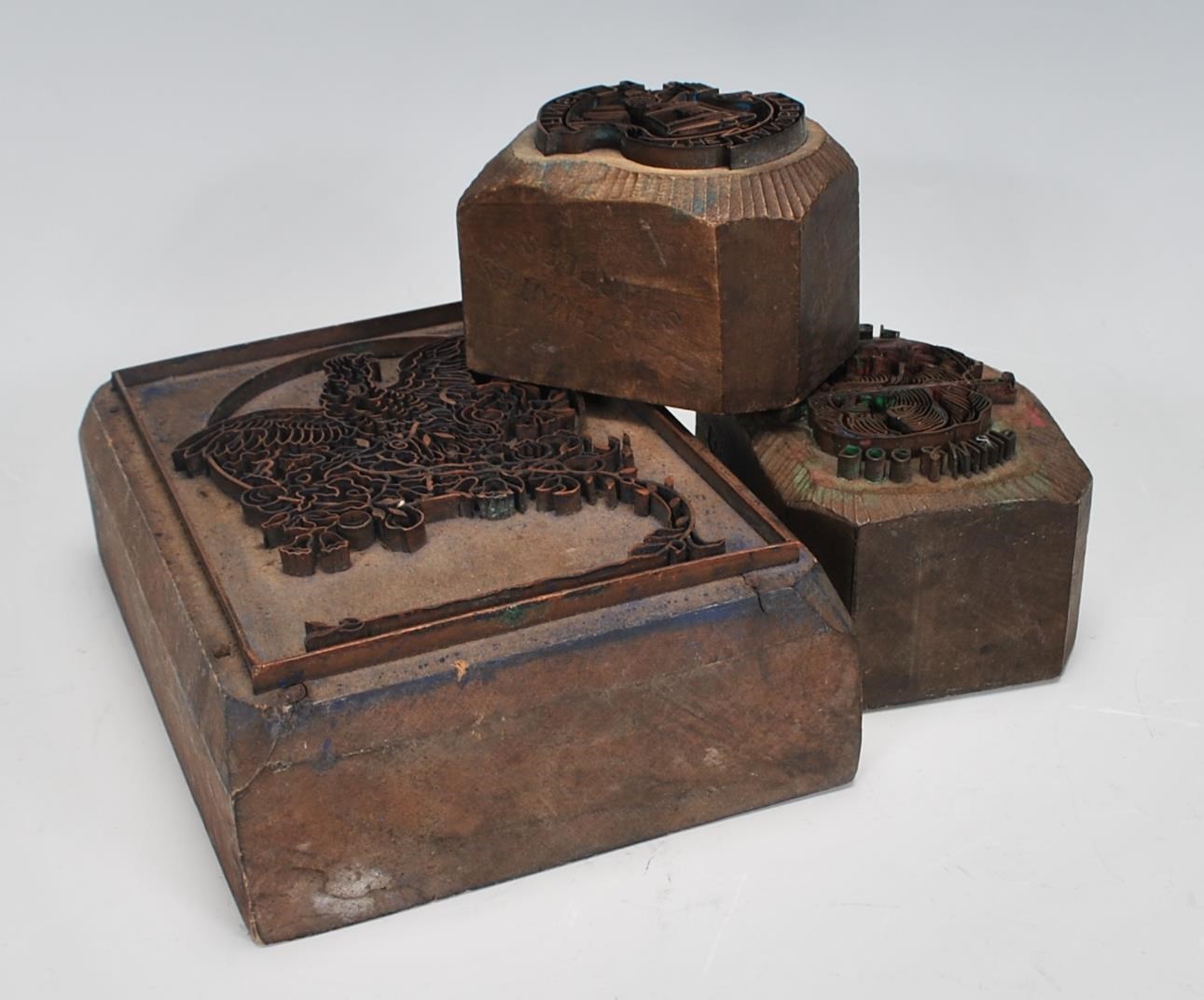 A group of three 20th Century wooden printing blocks one depicting a bird in flight, one reading '