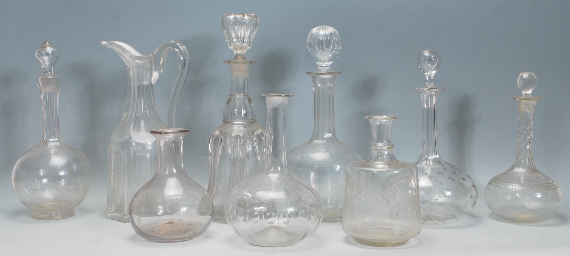 A good collection of mixed decanters dating from the 19th Century Georgian era to include a bell