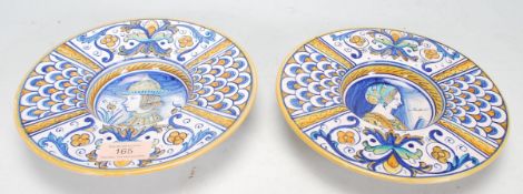 A pair of 20th Century majolica plates of round form having wide rims decorated with alternate