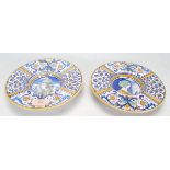 A pair of 20th Century majolica plates of round form having wide rims decorated with alternate