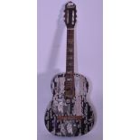 A vintage Dulcet spanish six string acoustic guitar, the body decorated with Dead Million stickers