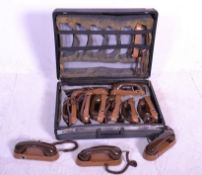 A cased set of twelve vintage retro 20th Century corded telephones within a black carry case. The