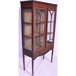 An early 20th Century Edwardian mahogany inlaid vitrine display cabinet being raised on square