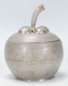 A vintage early 20th Century pewter tea caddie in the form of an apple having the stork forming