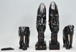 Two African tribal carved ebonised wooden statue ornaments having carved stylised faced with wire