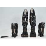 Two African tribal carved ebonised wooden statue ornaments having carved stylised faced with wire