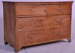 A 19th Century Georgian oak chest of drawers having two short over two long drawers with brass swing