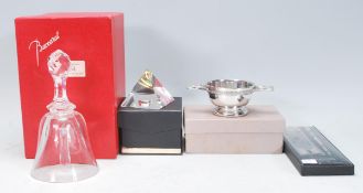 A collection of desktop items to include a Baccarat cut crystal glass commemorative bell acid etched