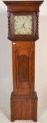 An early 20th Century oak long cased grandfather clock having a square face with hand enamelled dial