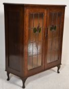 A 1920's stained glass and oak bookcase / china di
