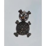 A ladies silver brooch in the shape of a teddy bear. The brooch is set with marcasites and