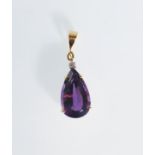 A 20th century 18ct gold pendant set with a tear drop cut amethyst and a round cut diamond above.