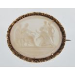 A late 19th / early 20th Century cameo brooch of oval form set with a conch shell panel decorated