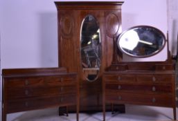 An Edwardian mahogany inlaid bedroom suite of good quality to include a dressing table chest,