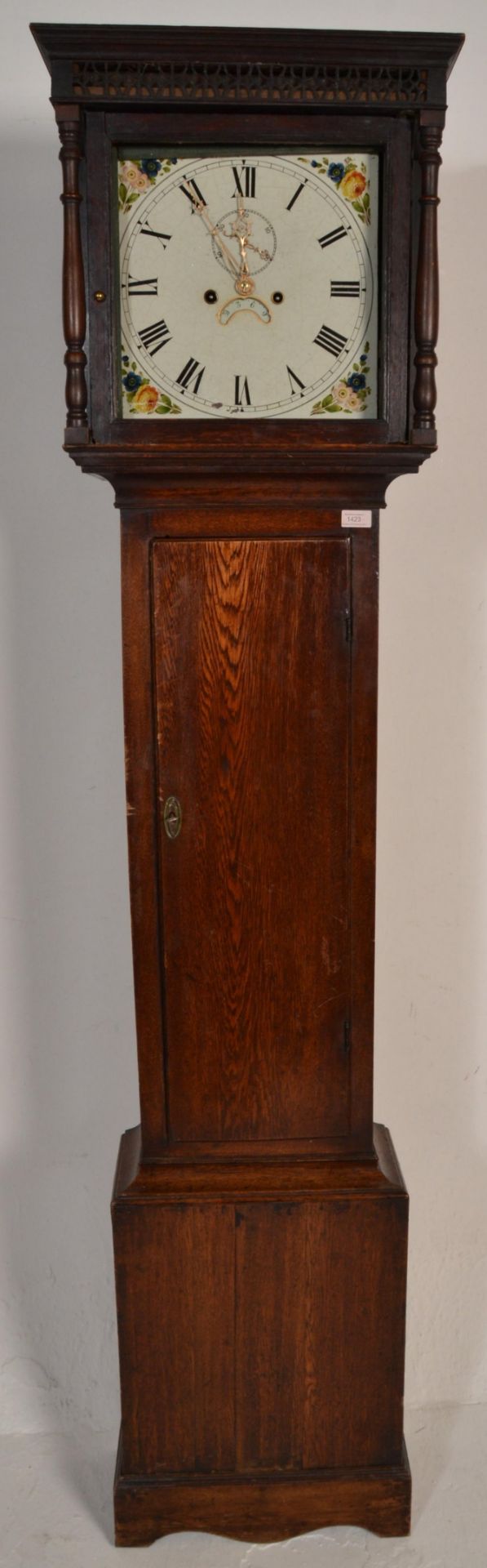 A 19th Century oak cased grandfather / longcase clock having a painted face with floral decoration