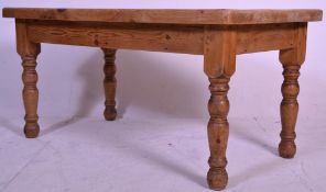 A Victorian style country pine refectory / scullery dining table being raised on  block and turned