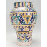 A late 19th / early 20th Century Moroccan pottery vase of waisted form having hand painted