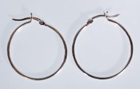 A pair of silver hoop earrings. Weigh 2.8g. Measur