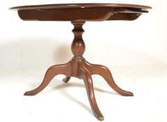 A 20th century Ercol beech and elm wood circular e