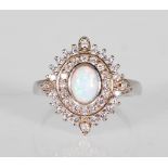 A silver ladies dress ring set with a central opal