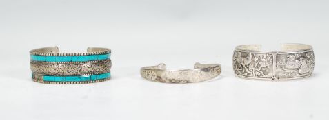 A group of three Chinese white metal bangles / bra