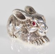 A silver figure of a rabbit set with ruby eyes. St