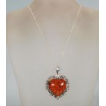 A large silver and amber style heart shaped pendan