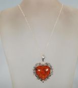 A large silver and amber style heart shaped pendan