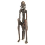 AFRICAN BRONZED FIGURAL STATUE OF A SEATED WOMAN