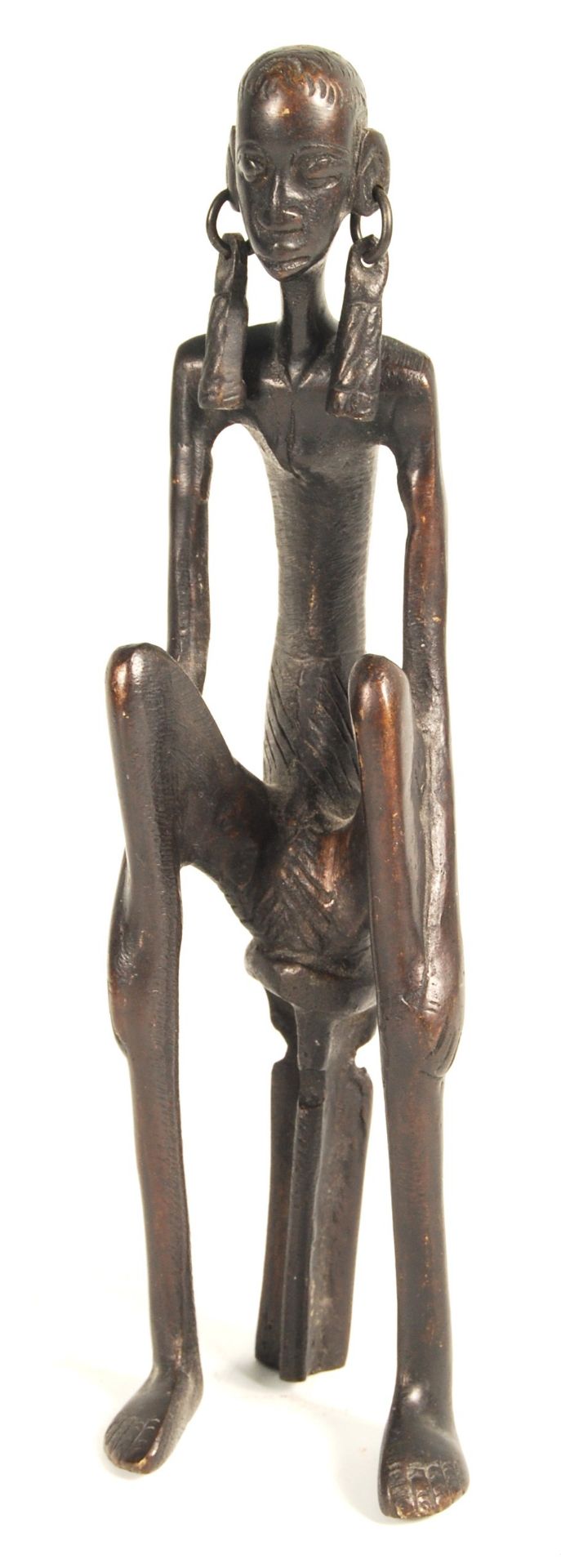 AFRICAN BRONZED FIGURAL STATUE OF A SEATED WOMAN